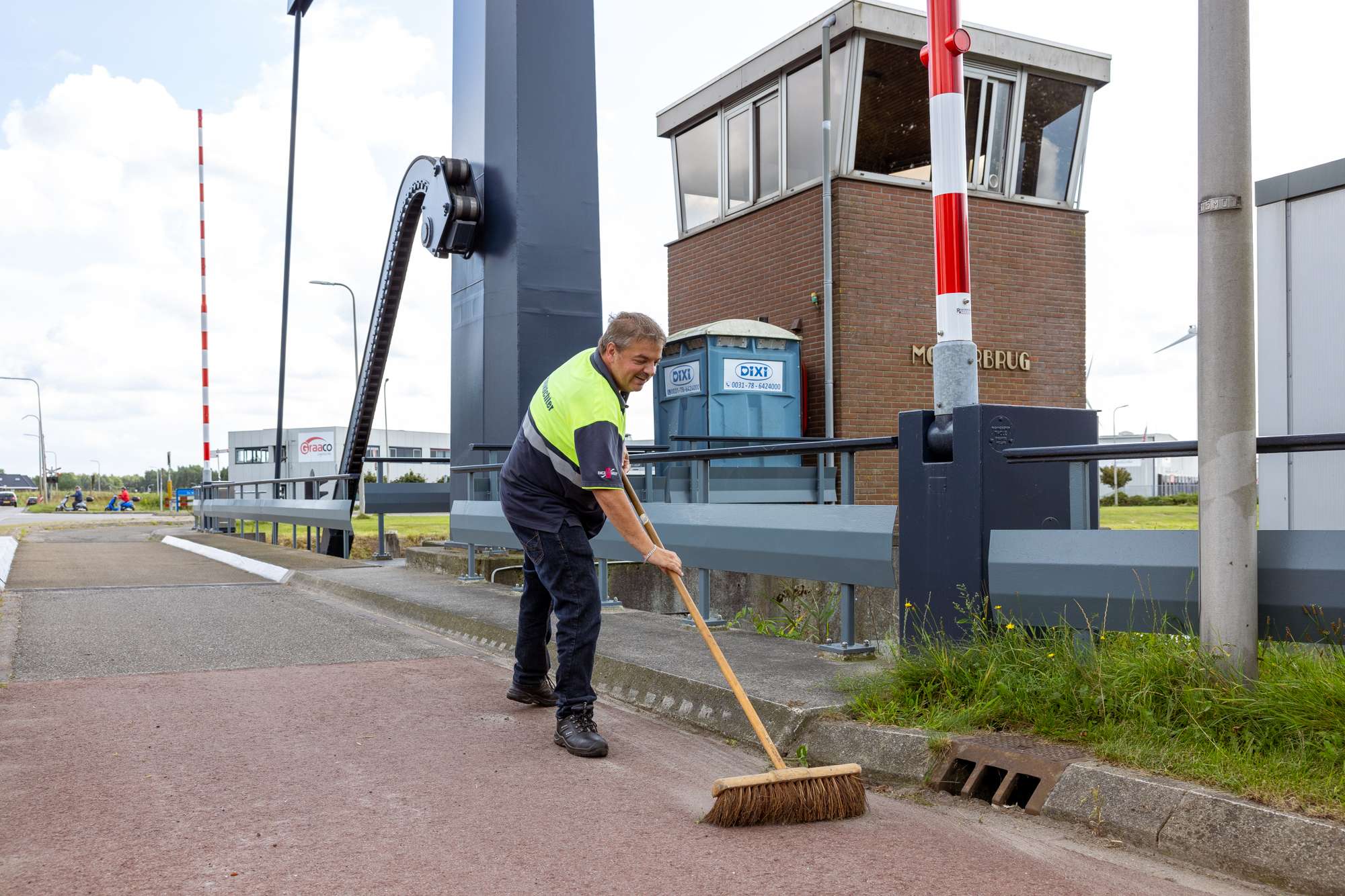 Brugwachter bezemt de brug